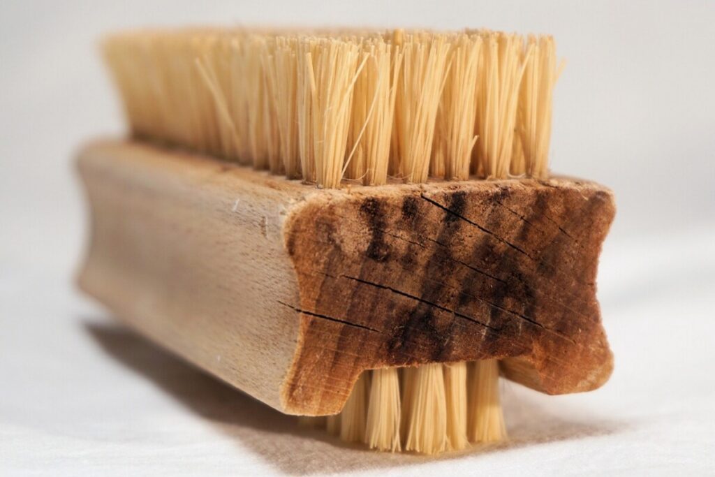 Wooden hand brush with natural bristles close up
