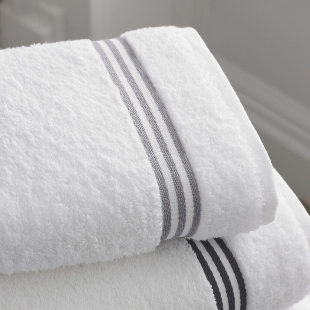 Folded white towels with gray stripes