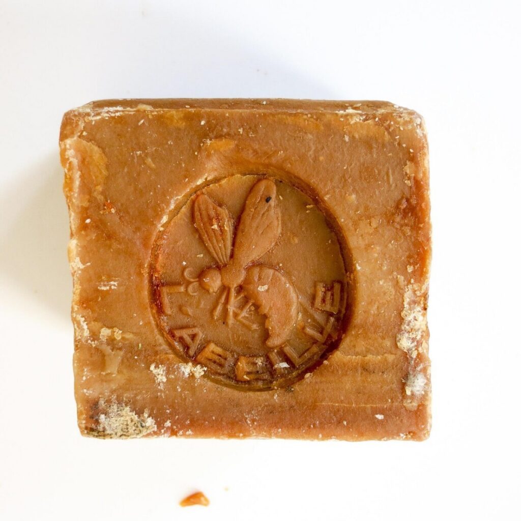 Brown block of Marseille soap with a bee emblem