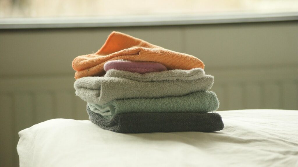 Stack of folded colored towels with a soap bar on top