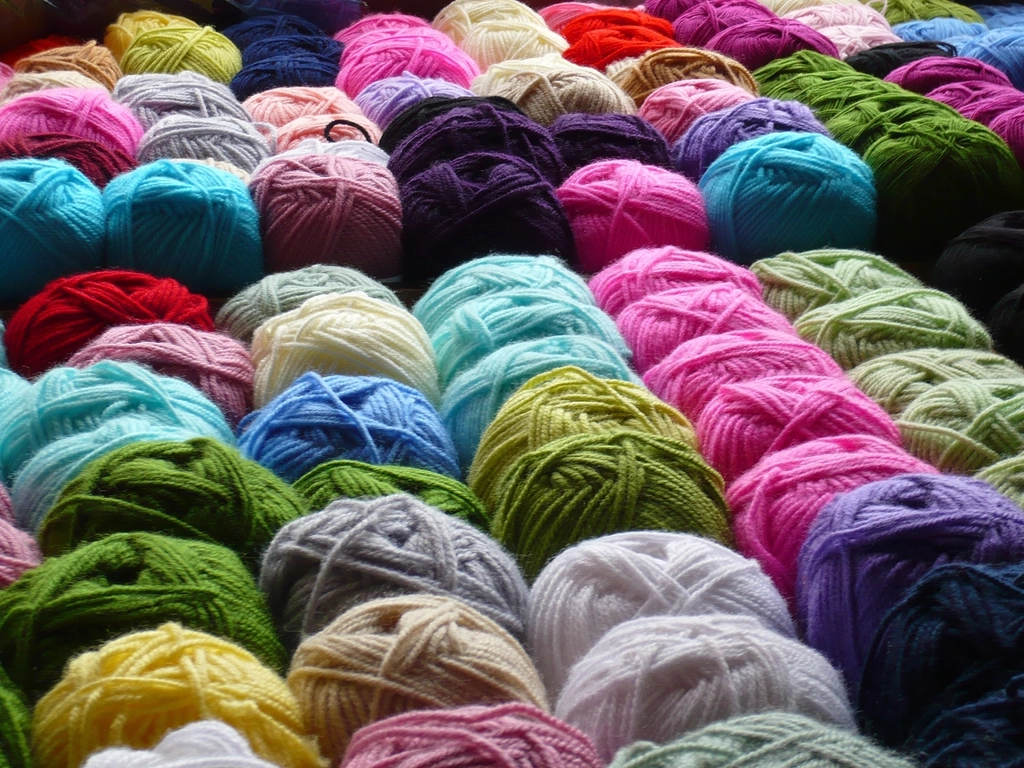 Rows of colorful wool yarn balls